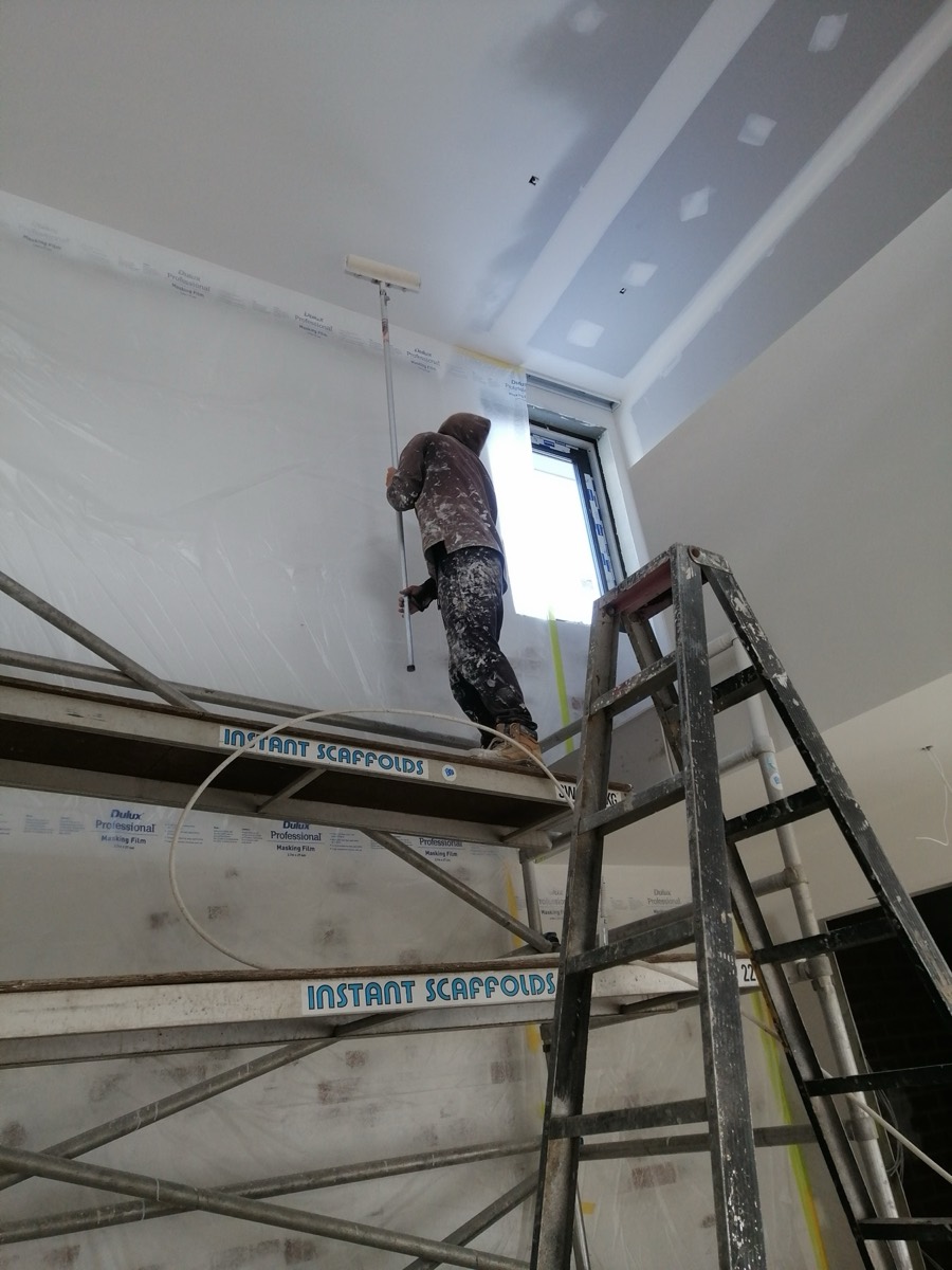 Ceiling being rolled from scaffold during a renovation