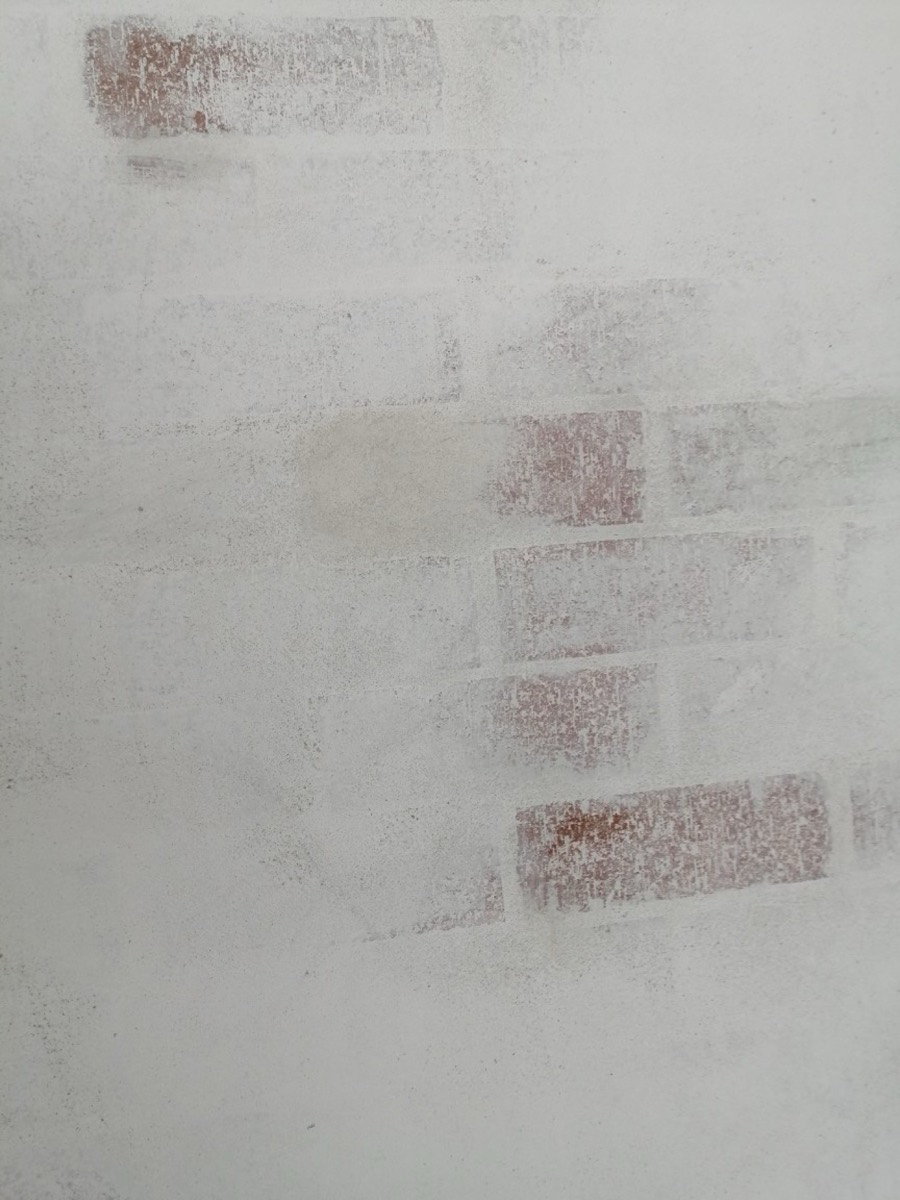 Whitewash finish applied over a brick wall